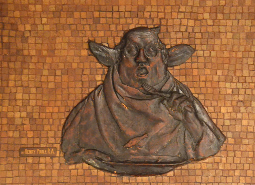 Grotesque friar with pig ears eating little fish in a soup dish